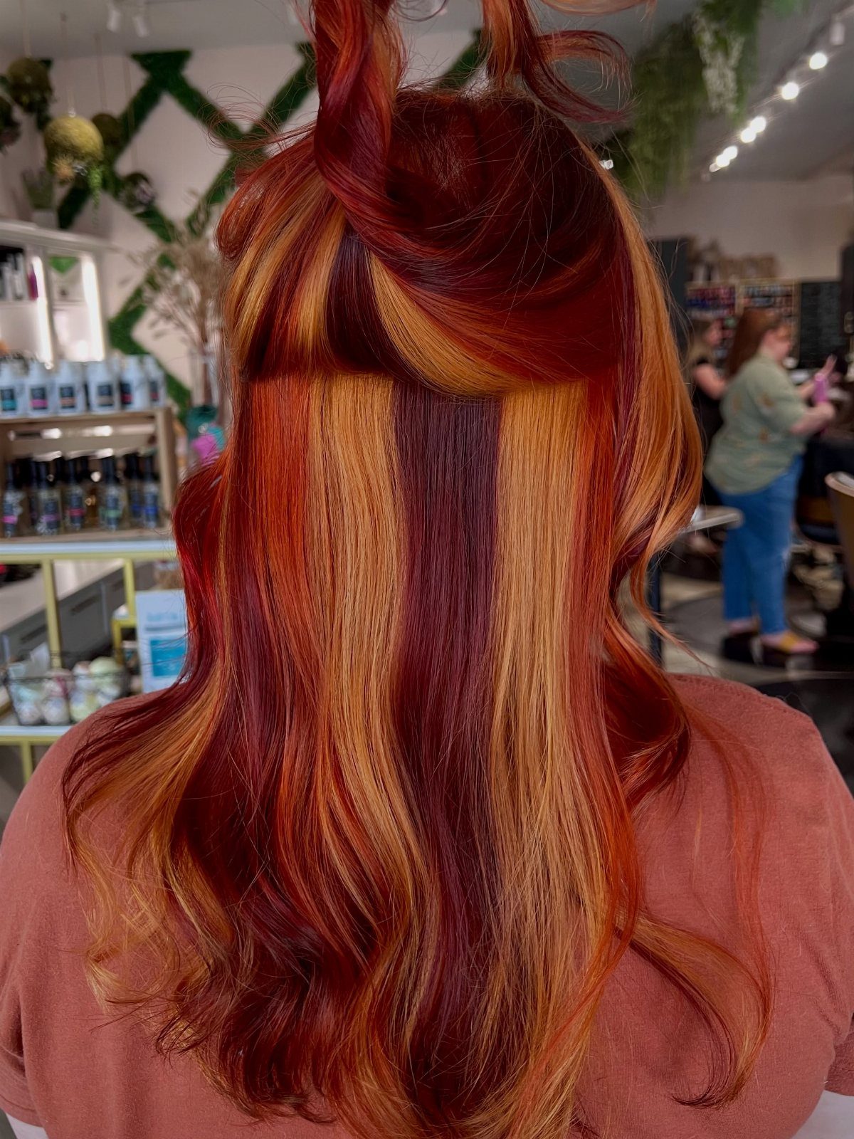 Long salon hair colored in vivid red, copper, orange, and golden blonde