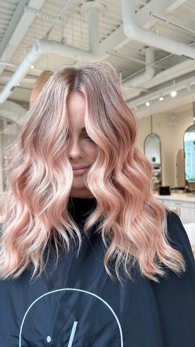 Long wavy peach-blonde hair with soft pink and copper tones
