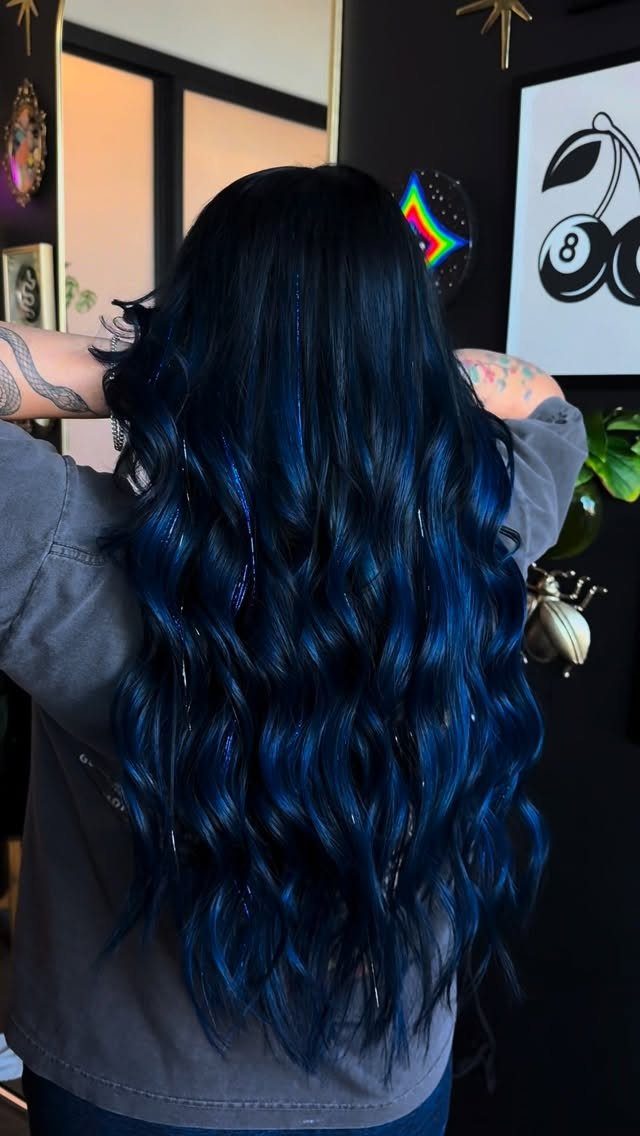 Long wavy black hair with vivid blue sheen shown from behind