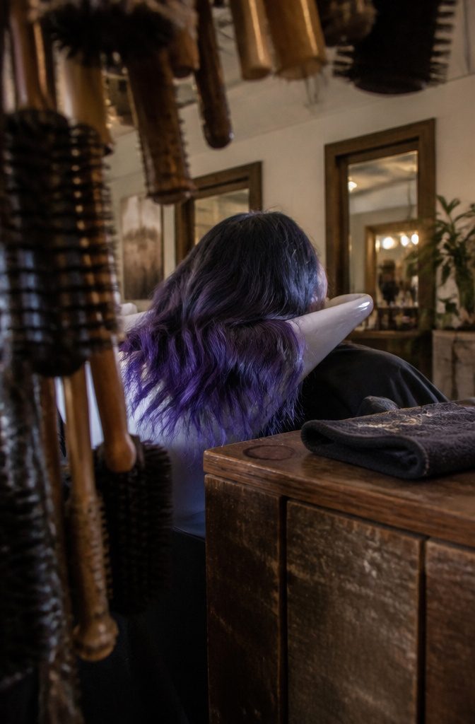 Dark hair blending blue and purple through the lengths
