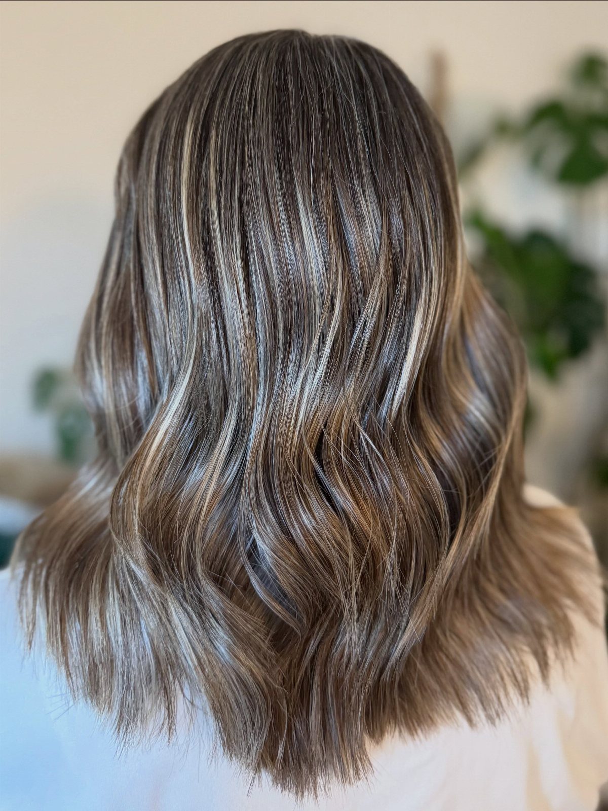 Wavy brown hair with frosted silver-white balayage highlights