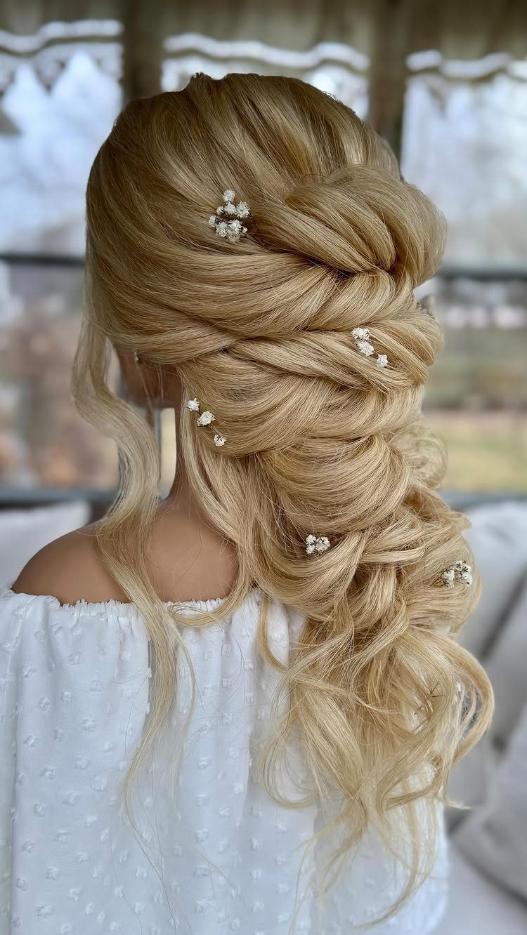 Blonde bridal half-up hair with braided twists, jeweled pins, and loose curls