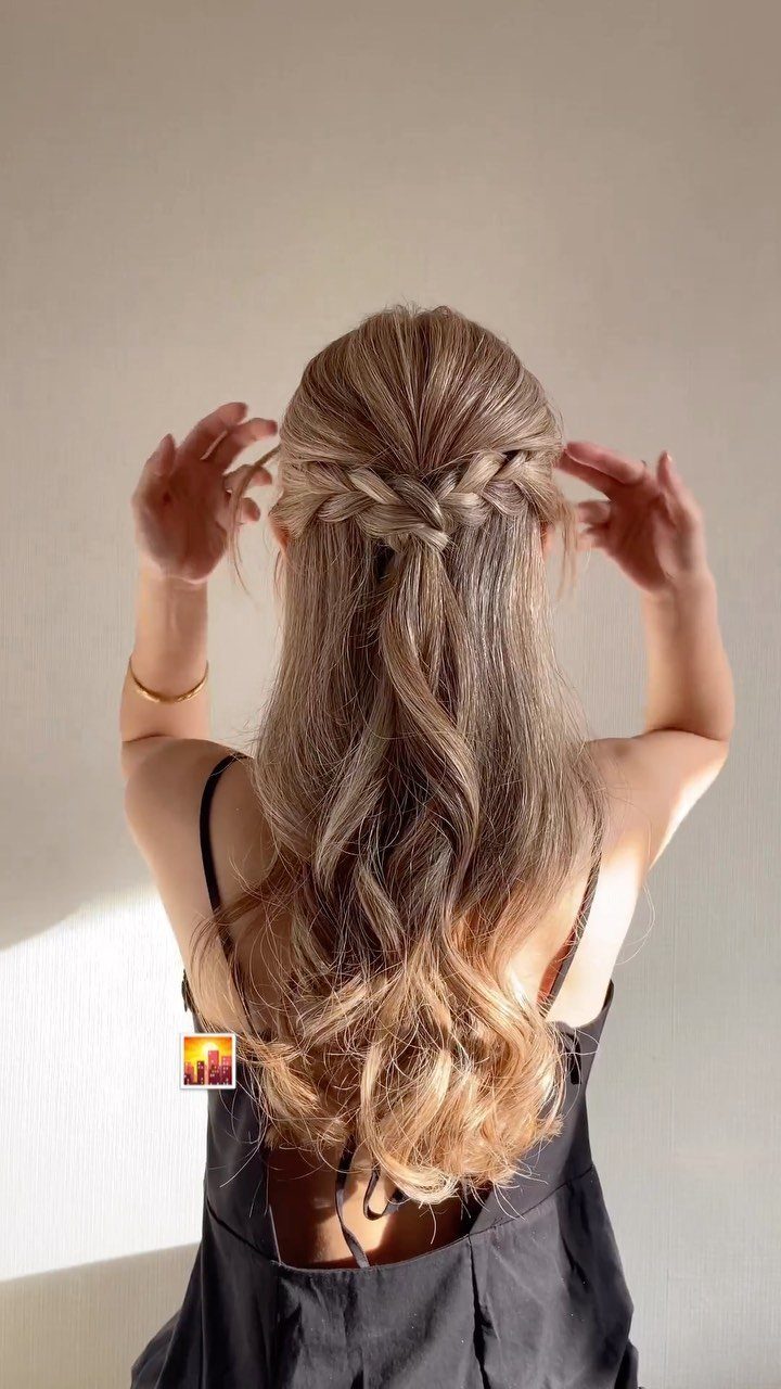 Ombre curls tied back in a half-up style on a woman viewed from behind