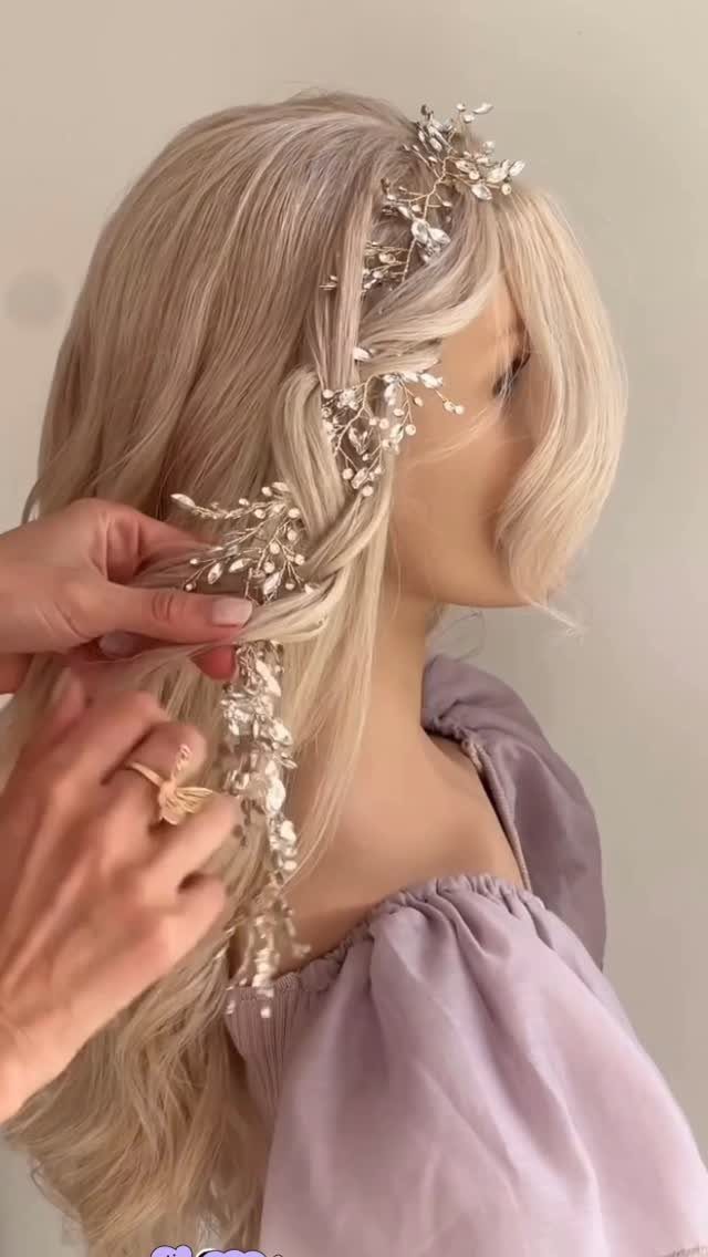 Long-haired woman has a thick decorated braid styled by hands beside her head