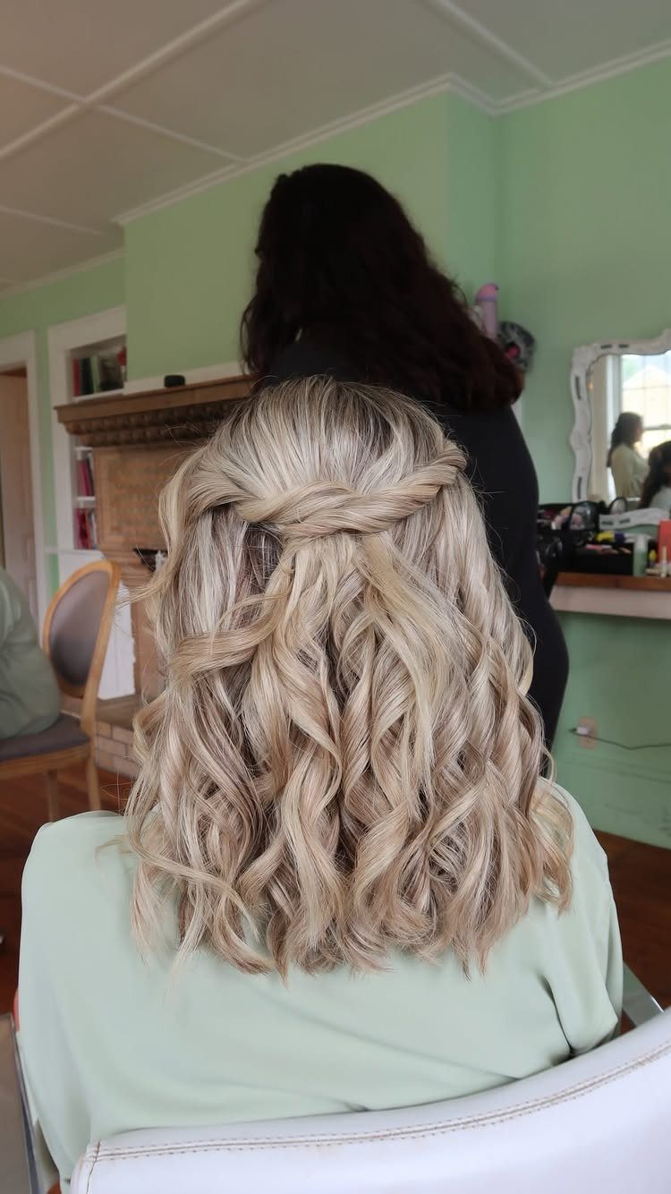Blonde half-up hairstyle with twisted sections and loose curls cascading down