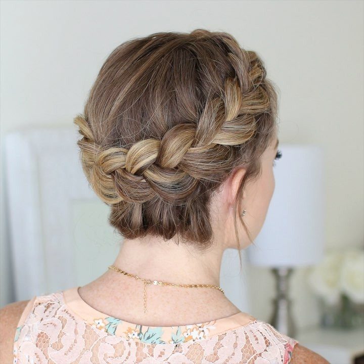Woman with a thick braided crown tucked into a low bridal updo