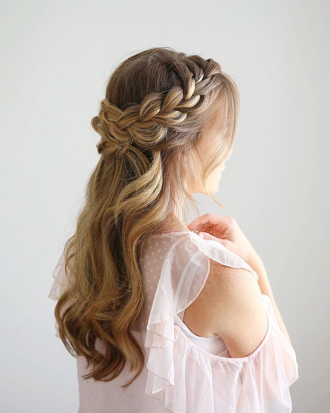 Half-up brown hair with a braided crown and loose cascading waves