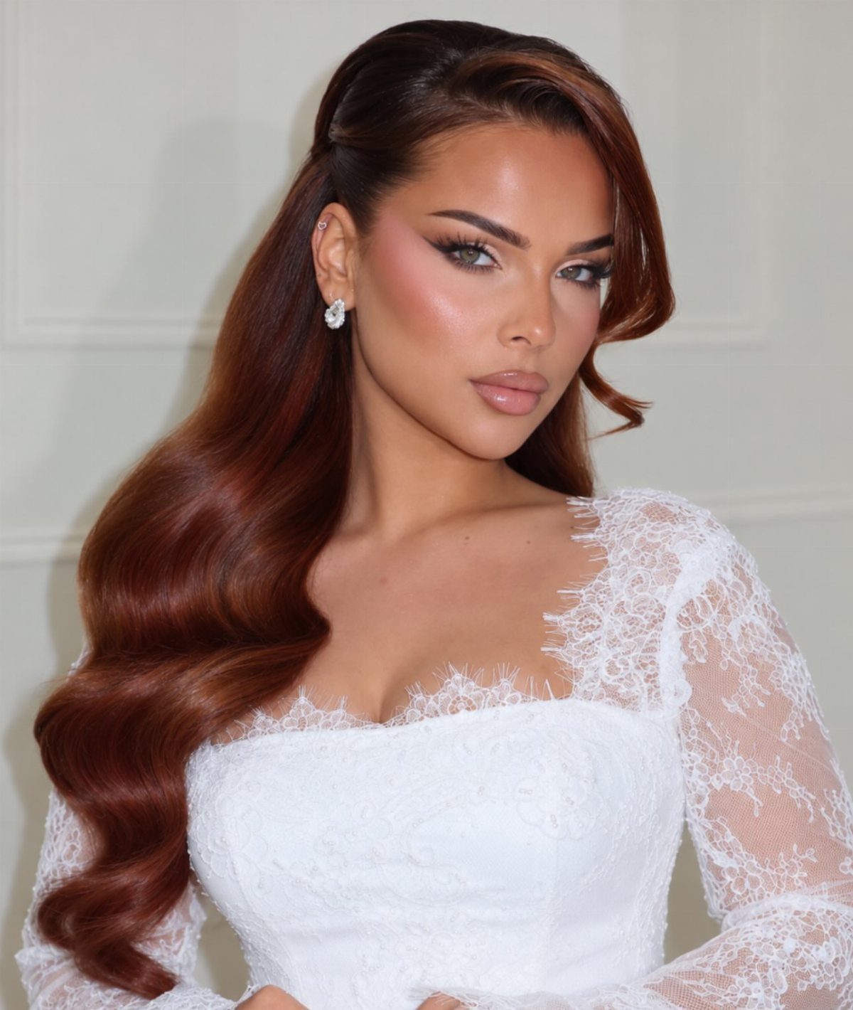 Bride with long reddish-brown hair styled in smooth, loose waves