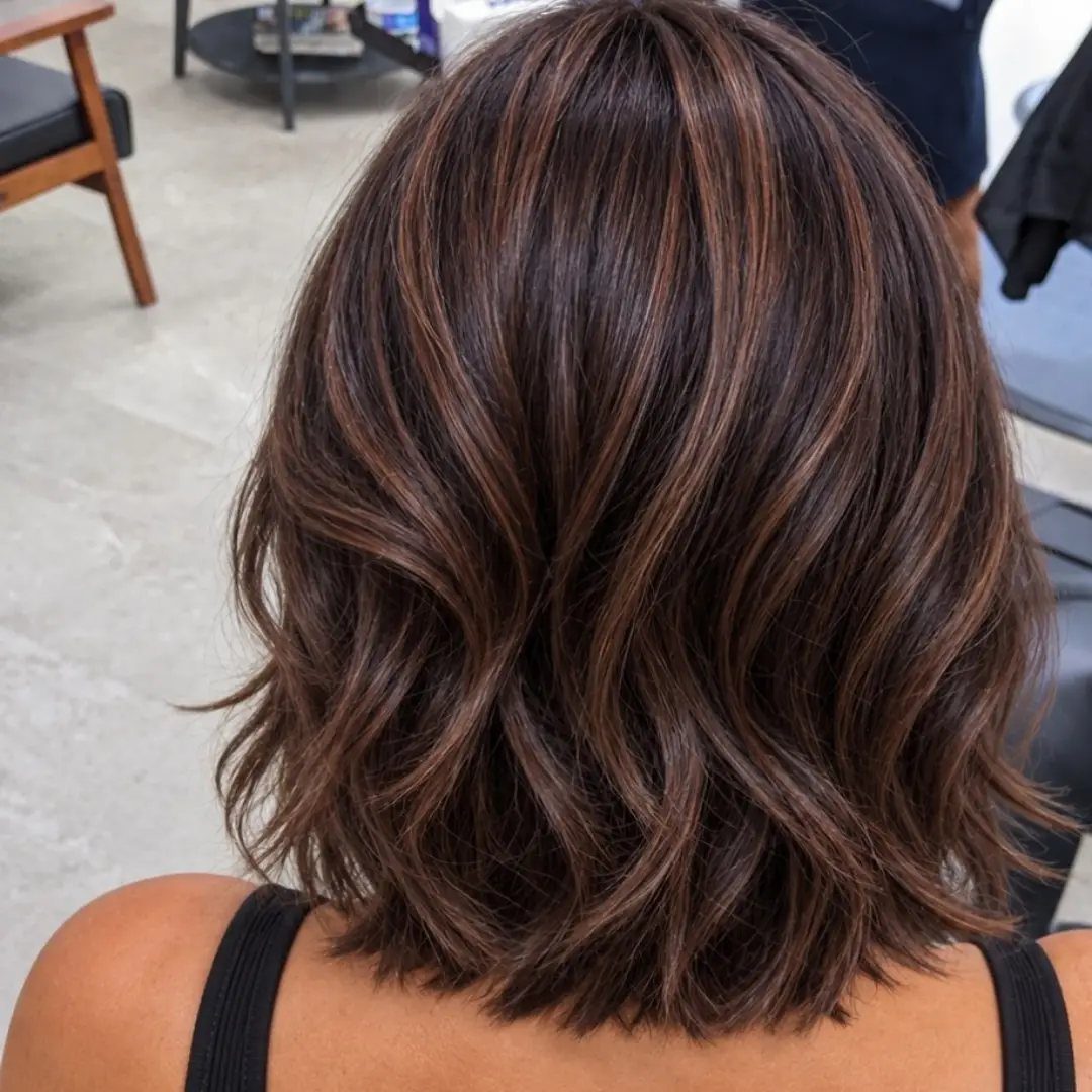 Layered brown hair with warm golden highlights seen from behind