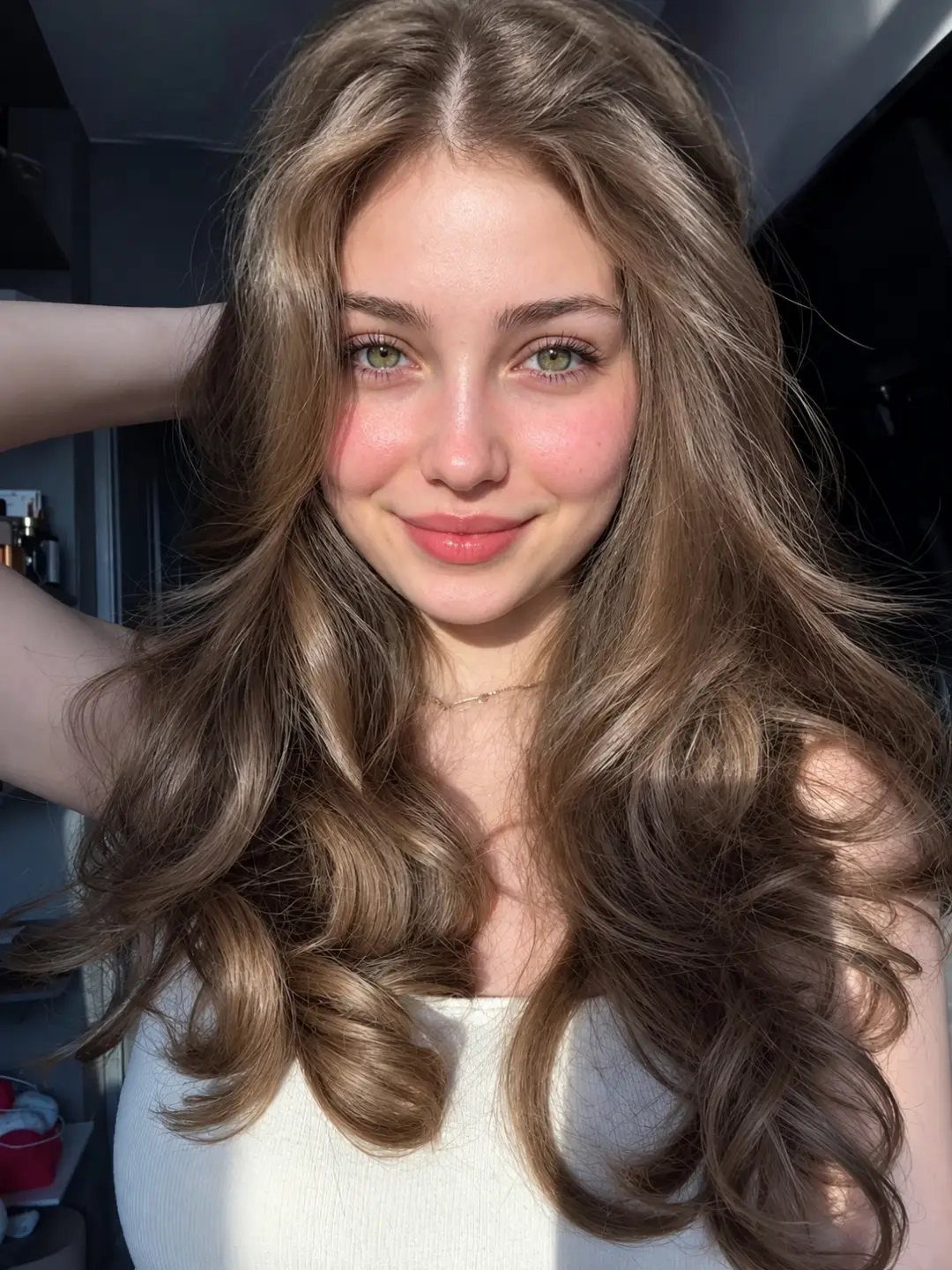 Young woman showing long, luminous warm light golden brown curls