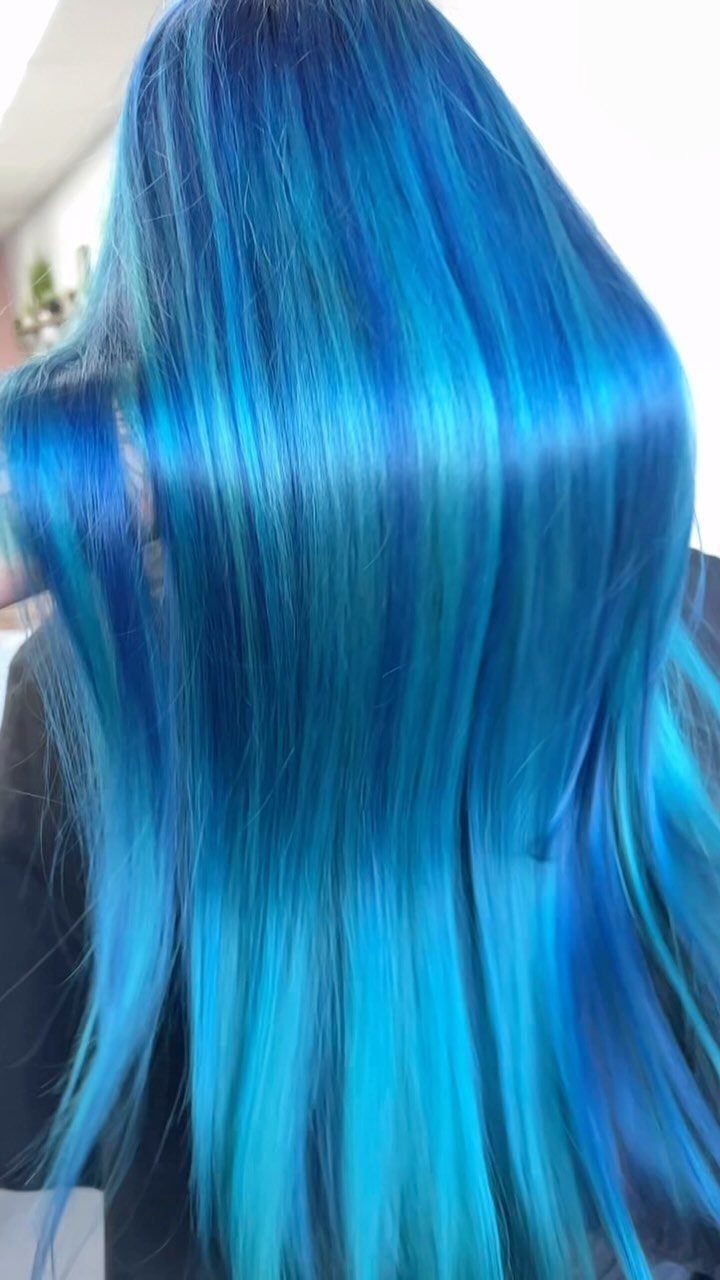 Long straight blue hair with vivid turquoise highlights and dark roots