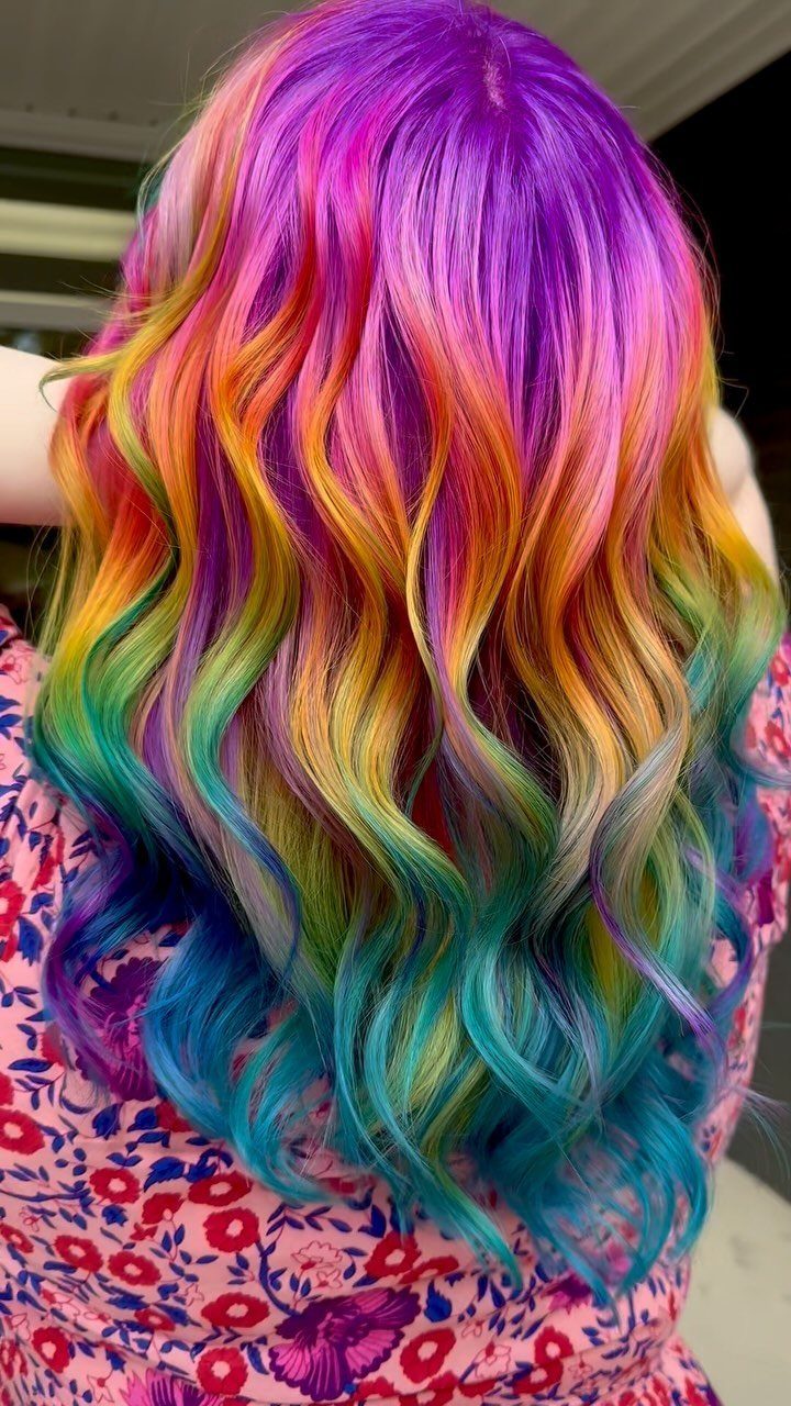 Long wavy rainbow hair with vivid purple, pink, yellow, green and teal