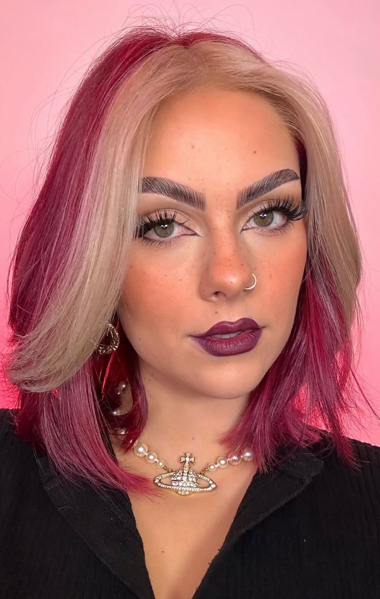 Woman with blonde and burgundy-red color-blocked shoulder-length hair