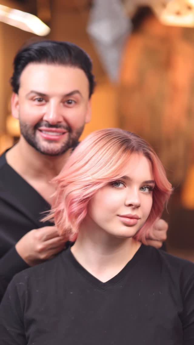 Woman with dimensional pink and blonde hair in a salon