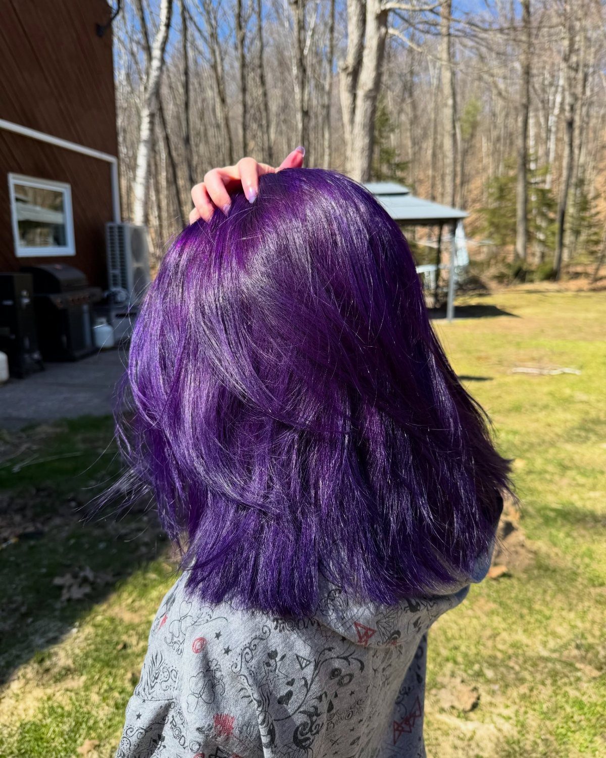 Shoulder-length deep violet hair with feathered layers seen from behind
