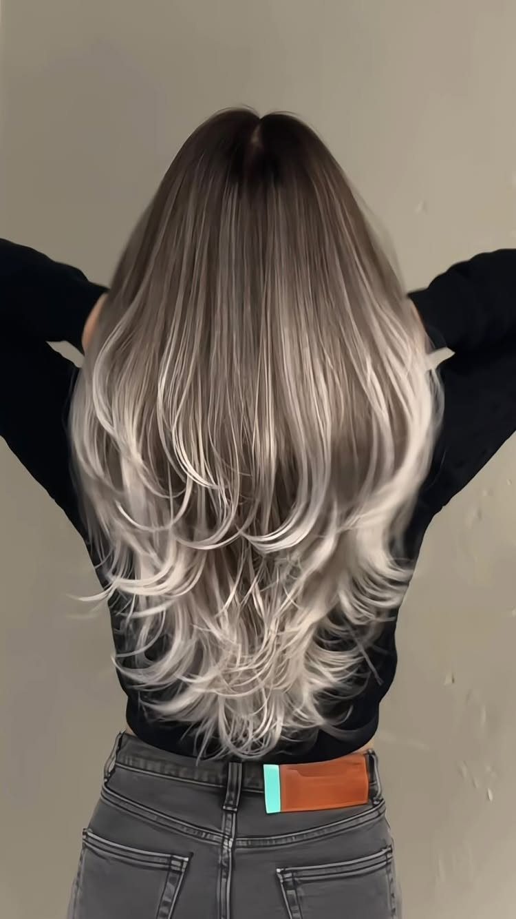 Long layered hair with dark roots and multidimensional cool ash-brown balayage