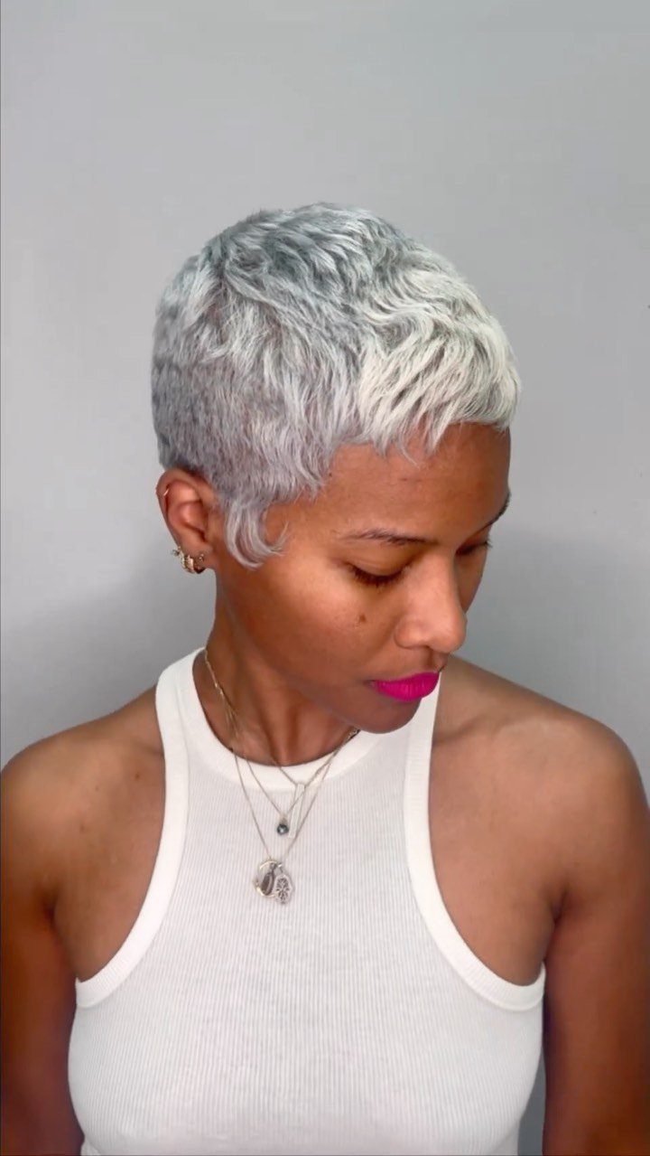 Short silver-gray pixie cut with textured layers and closely cropped sides