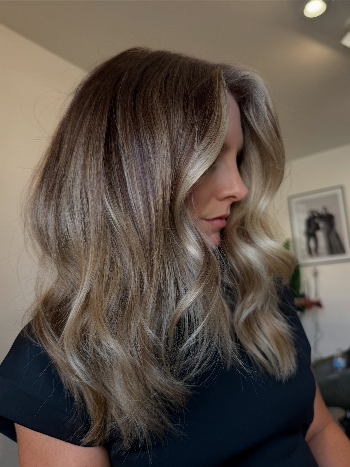Wavy dark brown hair with blended gray and silver-beige highlights