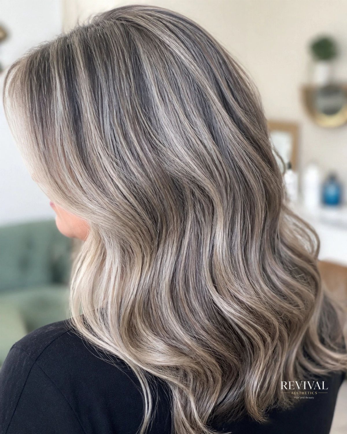 Wavy dark hair with cool-toned platinum and silver highlights