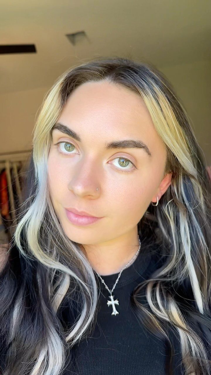 Long dark hair with bold pale blonde face-framing streaks