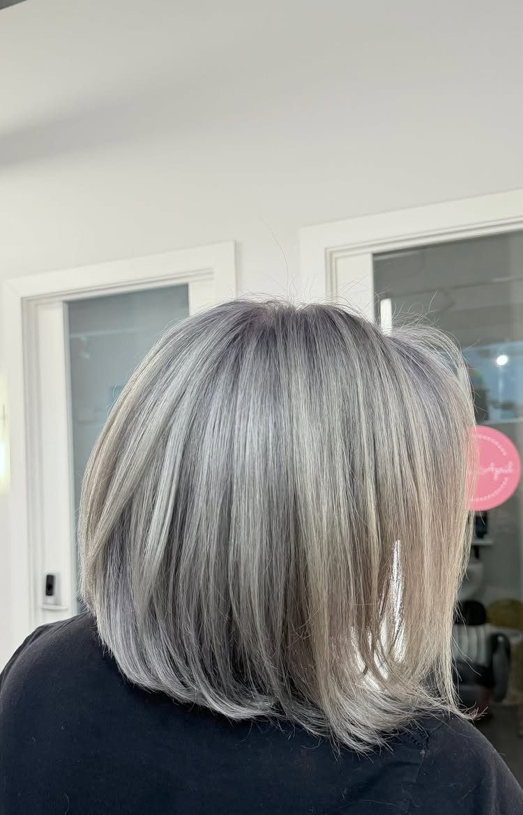 Silver and dark grey strands blend through a smooth, chin-length bob