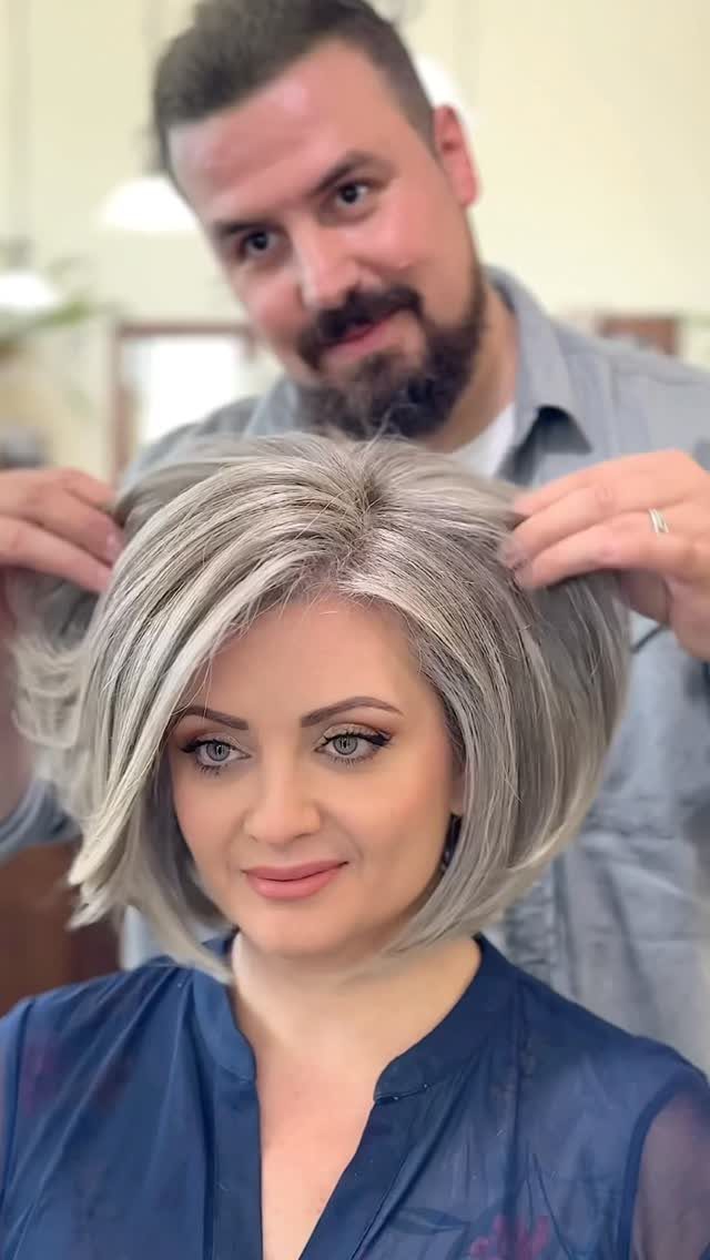 Woman wearing a smooth silver-grey shoulder-length bob hairstyle with side part