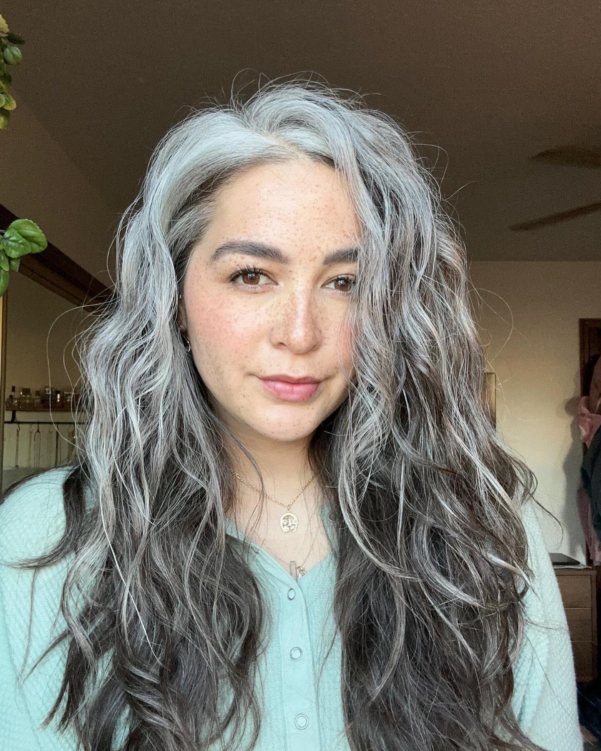 Woman with long silver and salt-and-pepper hair in loose waves