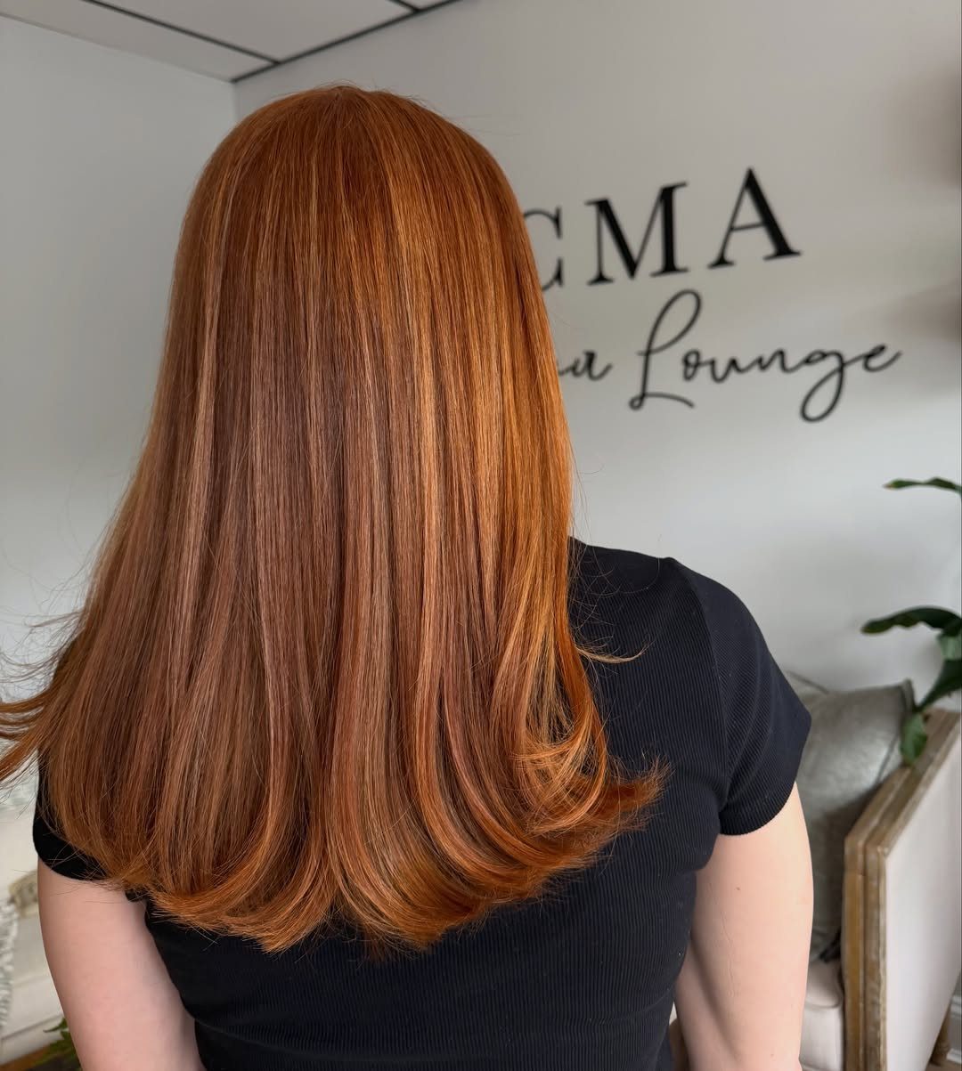Coppery golden-orange hair falls to the shoulders with softly curled-under ends