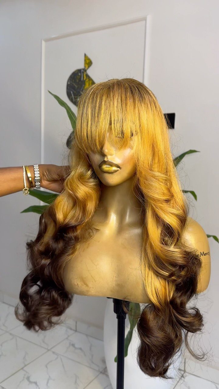 Mannequin head displaying long, wavy light-brown hair with darker ends