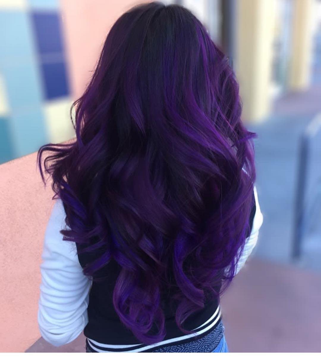 Long curled amethyst-plum hair with vivid violet highlights seen from behind