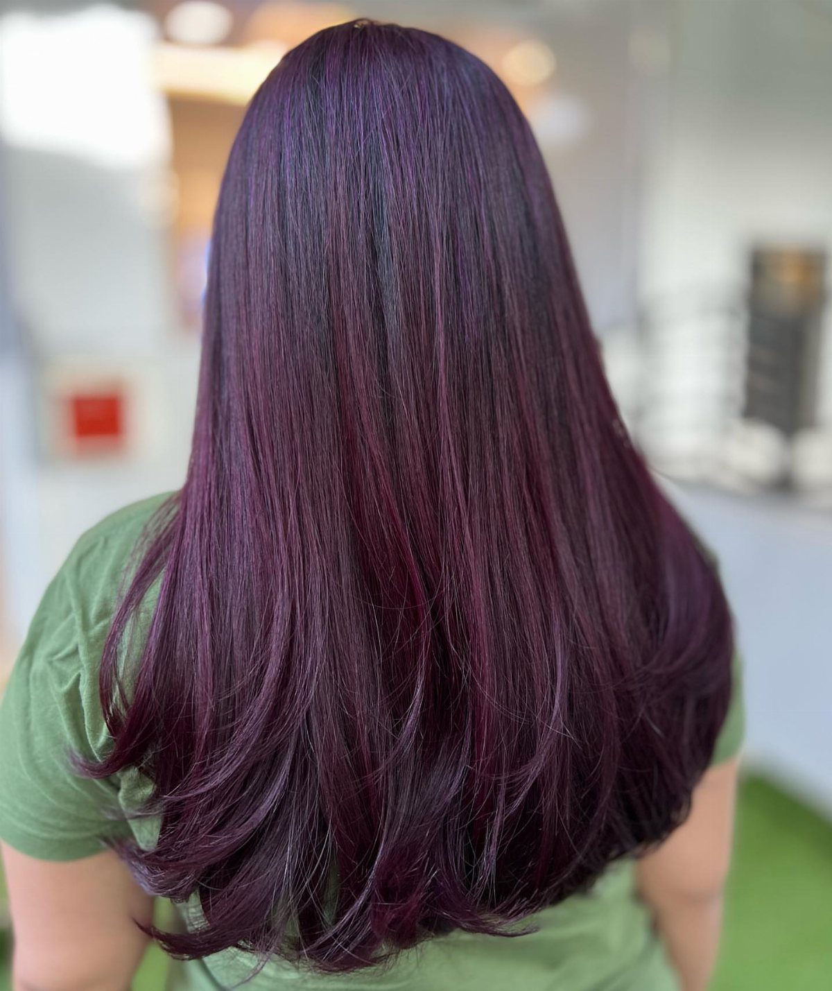 Long deep plum-purple hair with curled ends viewed from behind