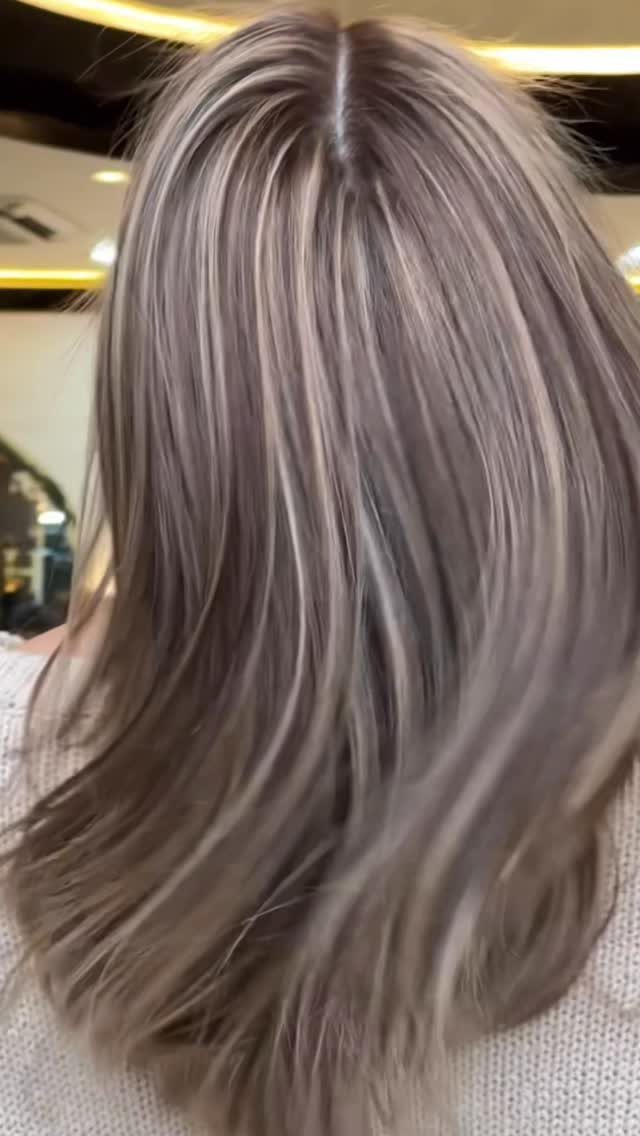 Smoky ash-brown hair with cool gray highlights viewed from behind