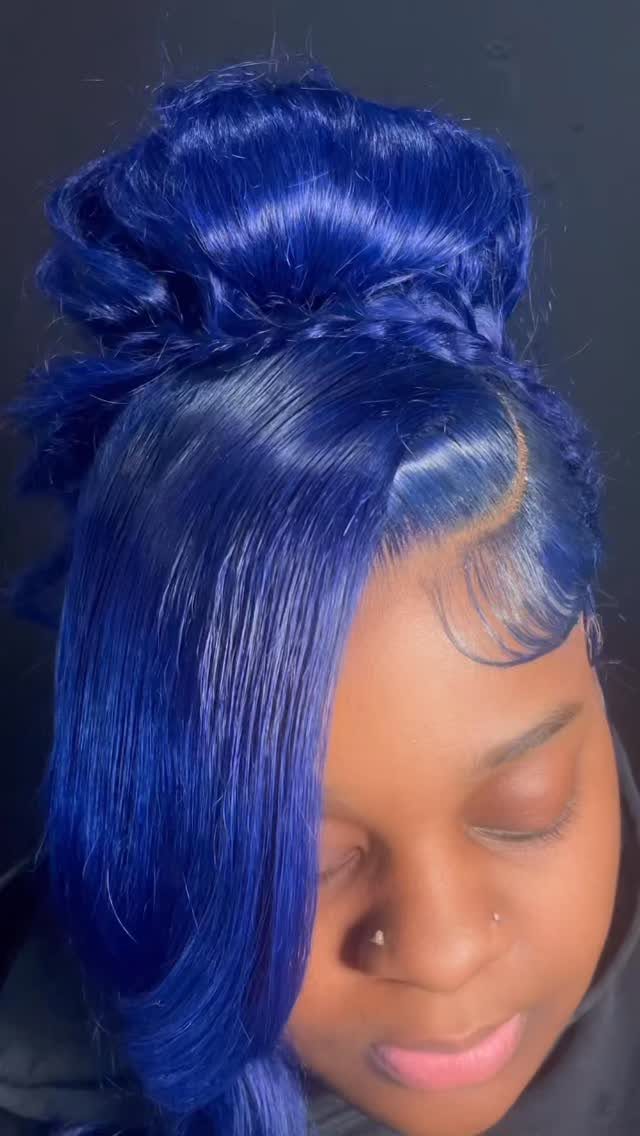 Vivid blue hair styled in a high bun with long, smooth side-swept sections