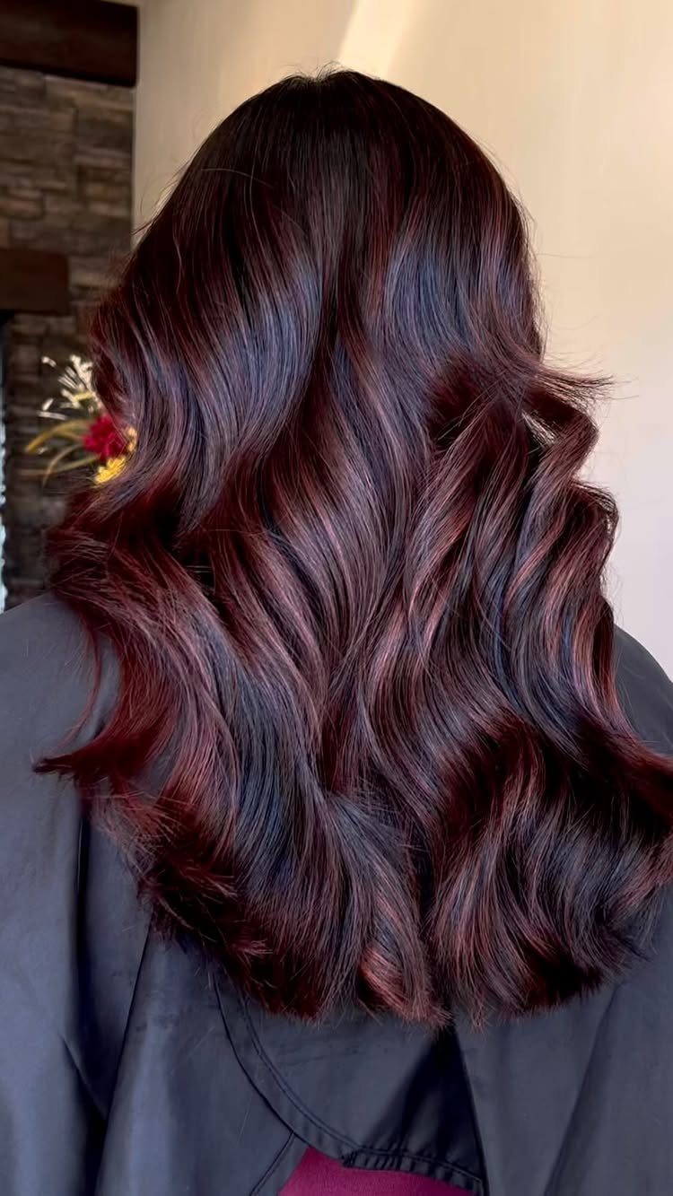 Long wavy mahogany hair with glossy red-violet tones