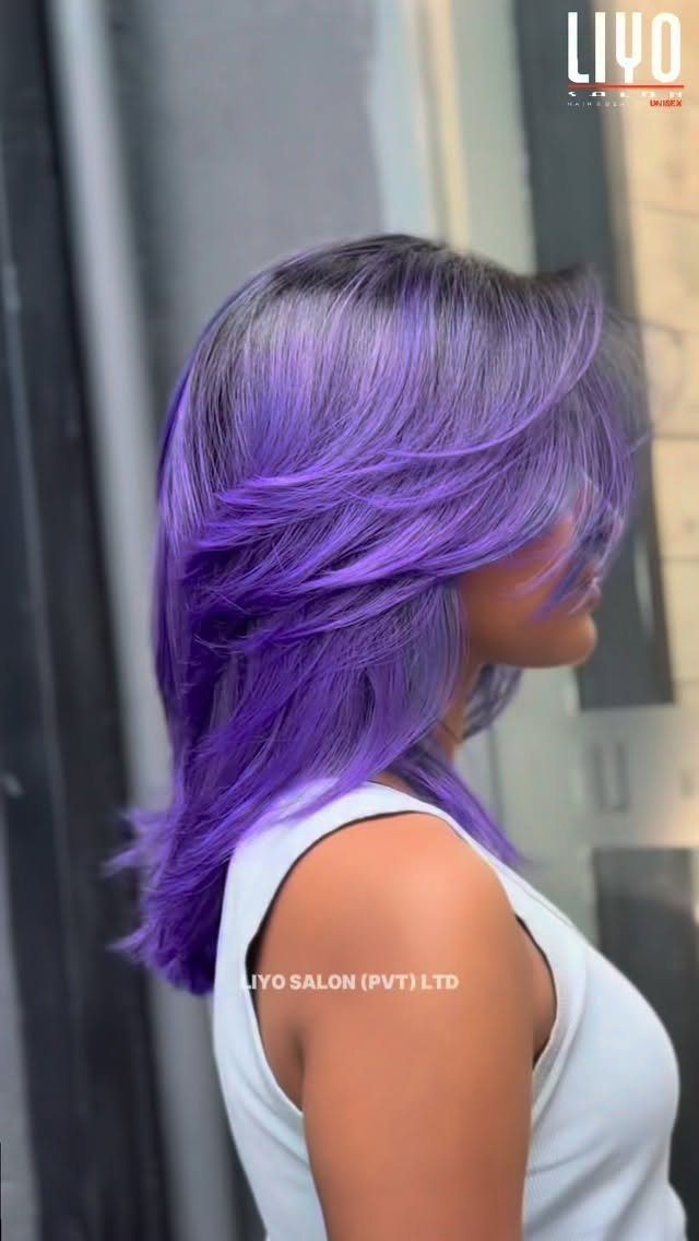Layered violet-purple hair shown in profile beside a glass doorway