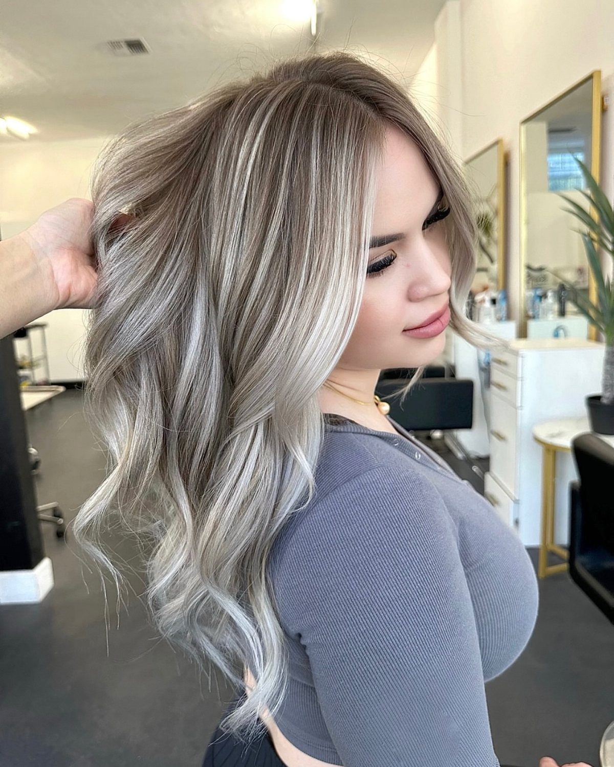 Woman displaying long ash-blonde hair with delicate, fine highlights