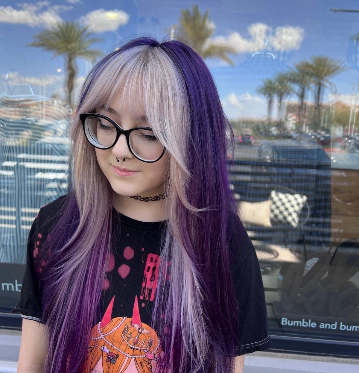 Long hair combines pale lavender sections with deep purple coloring