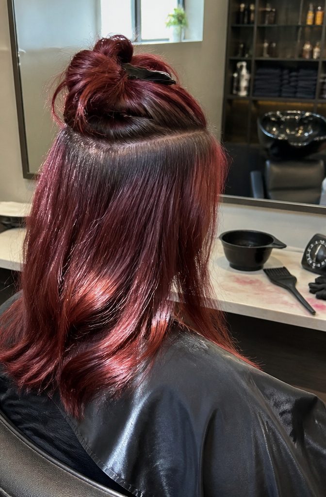 Hair showing permanent color with visible natural roots growing back