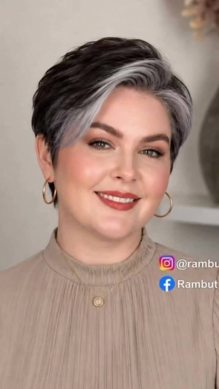 Woman with a short layered haircut featuring dark and silver-gray hair