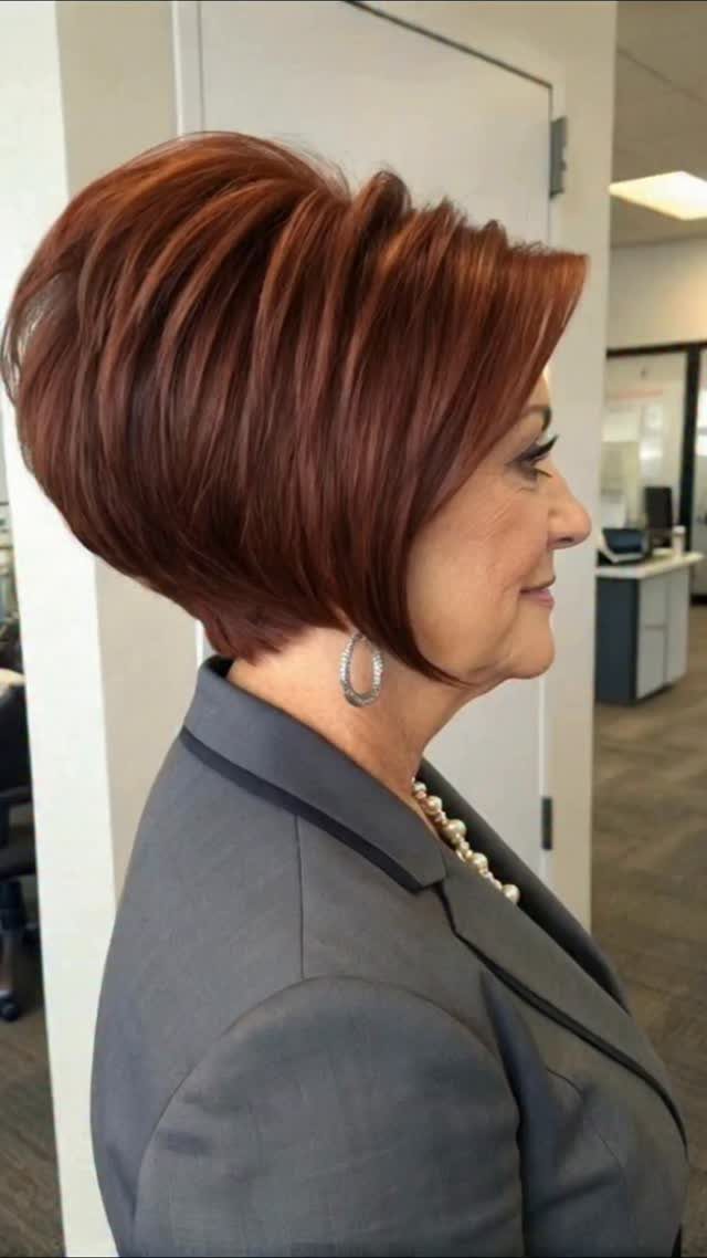 Woman in profile showing a voluminous layered reddish-brown bob haircut