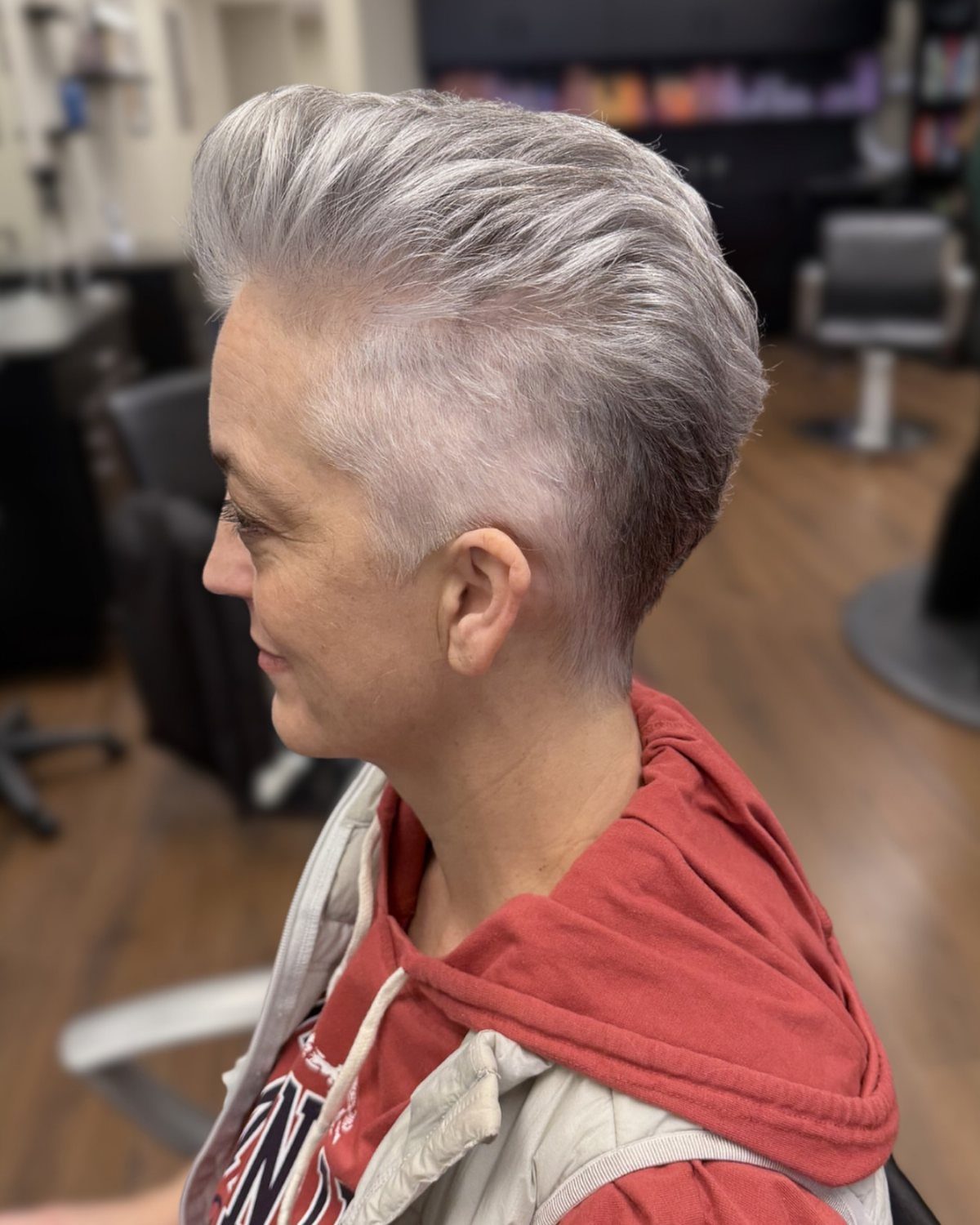 Silver-gray hair with a swept-back top and closely shaved sides in a salon