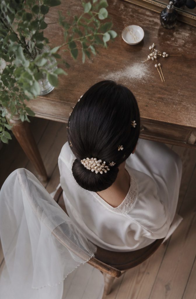 Pearl pins sprays and statement clips arranged beside a bridal hairstyle