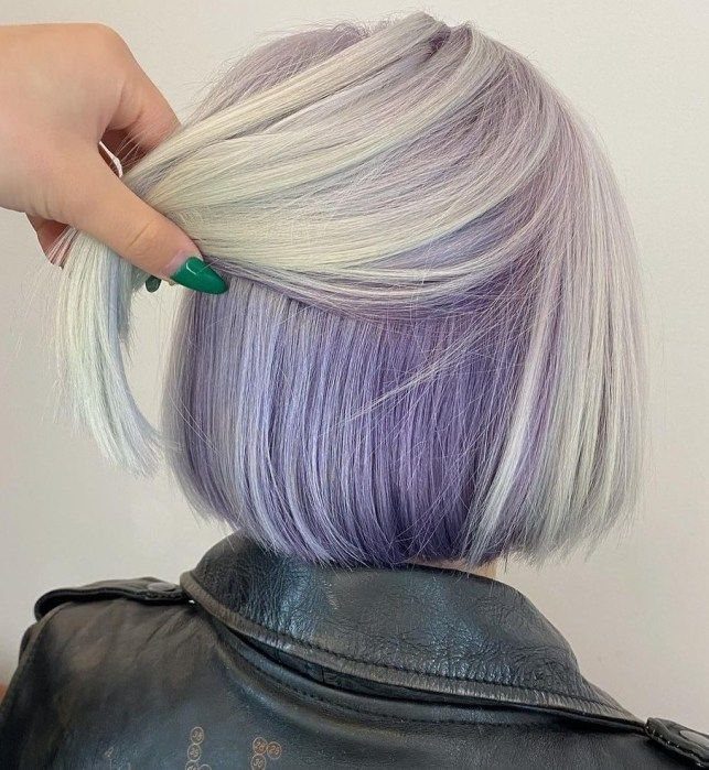 Silver-gray bob lifted to reveal vivid purple peekaboo sections underneath