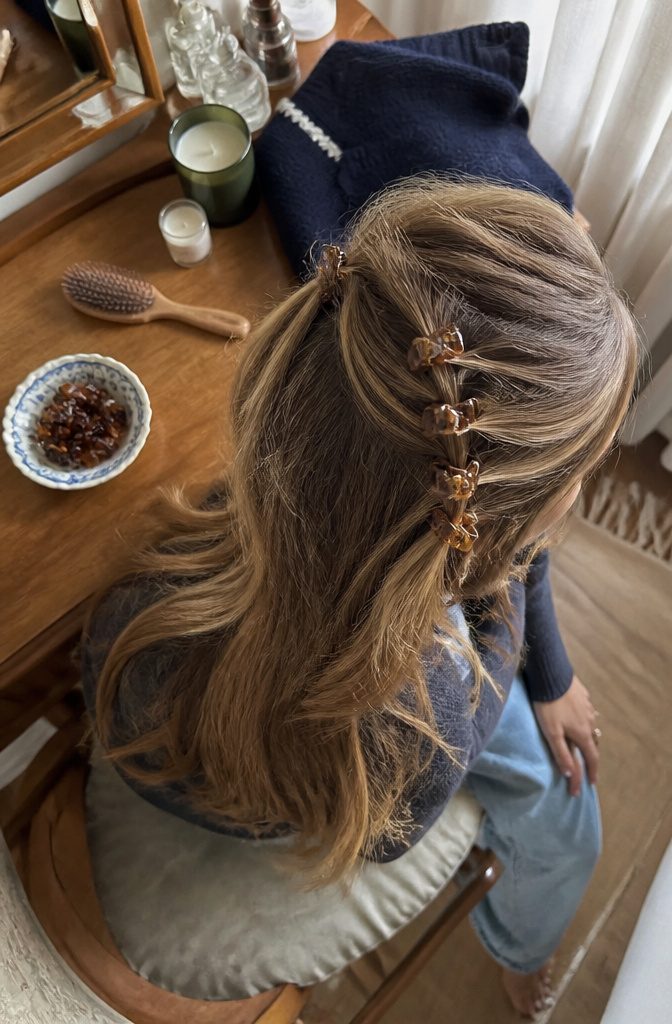 Hair pulled back with several miniature claw clips