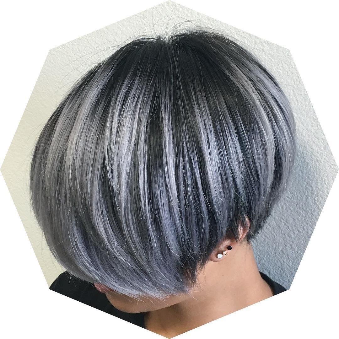 Layered silver-gray bob with charcoal roots and a sweeping fringe
