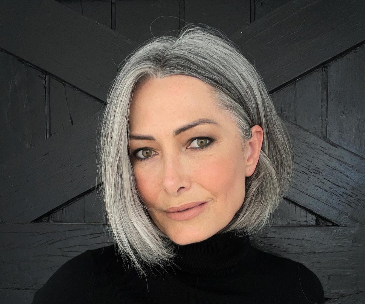 Woman modeling a silver-gray textured bob with volume and softly layered ends