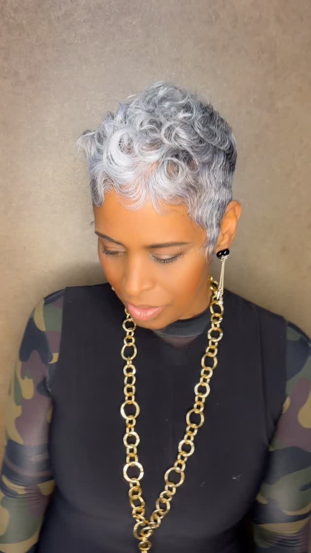 Woman with tiny silver curls styled in a short pixie cut