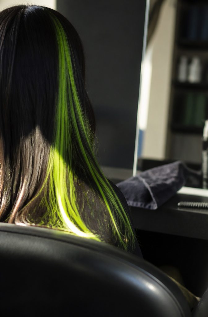 Neon green streak beside dark hair