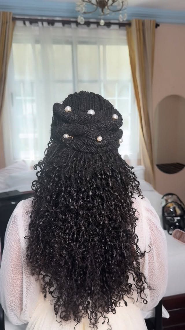 Twisted curly updo decorated with small white pearl hair pins