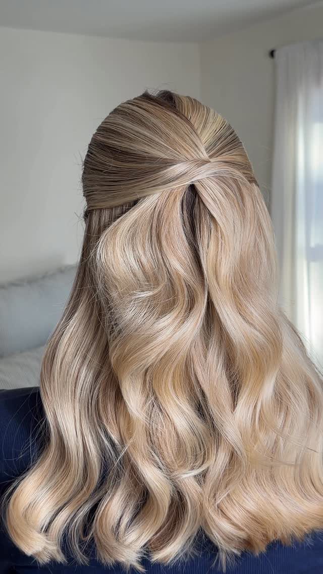 Blonde half-up hairstyle with long loose waves cascading down the back